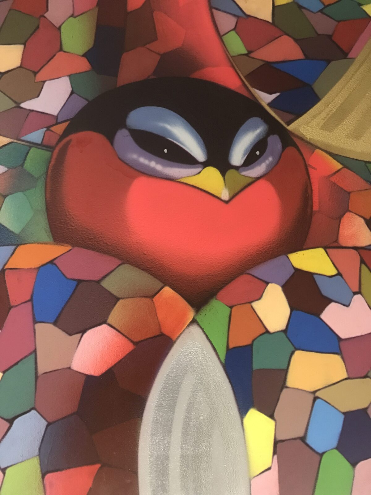 Stained glass art featuring a vibrant red cardinal bird.