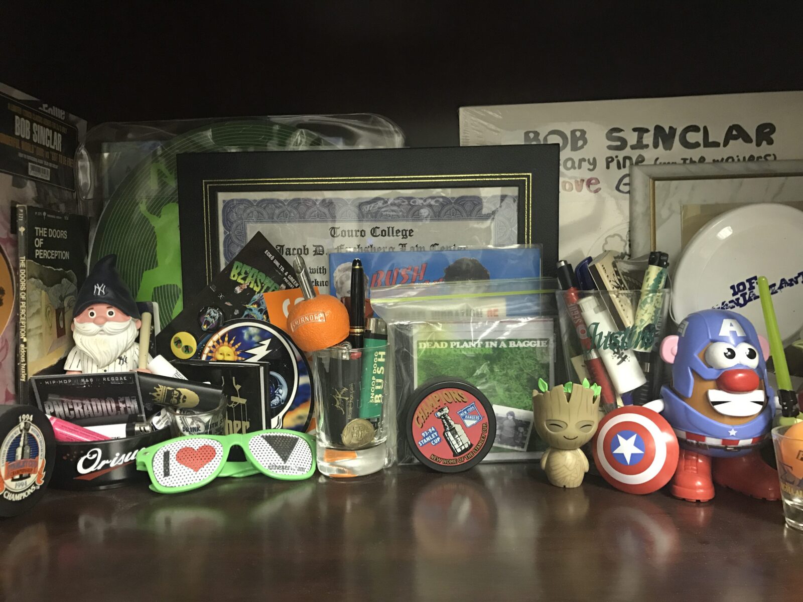 A collection of eclectic toys and memorabilia on a shelf.