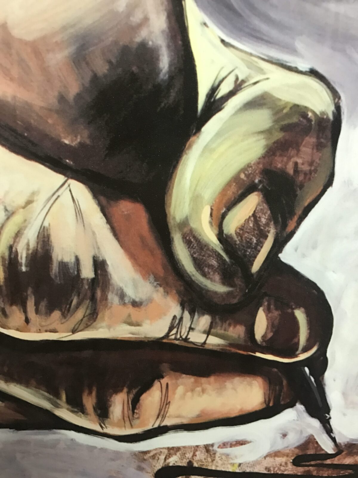 Close-up of a hand gripping a metallic object.