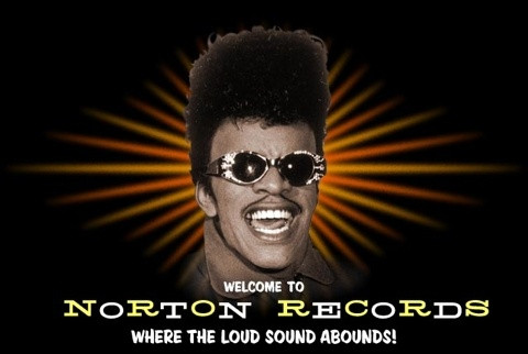 Smiling man with sunglasses and afro hairstyle in front of TorTon Records logo.