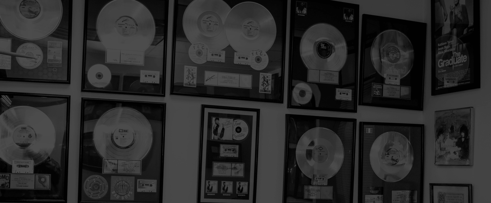 Wall decorated with framed gold and platinum music awards.